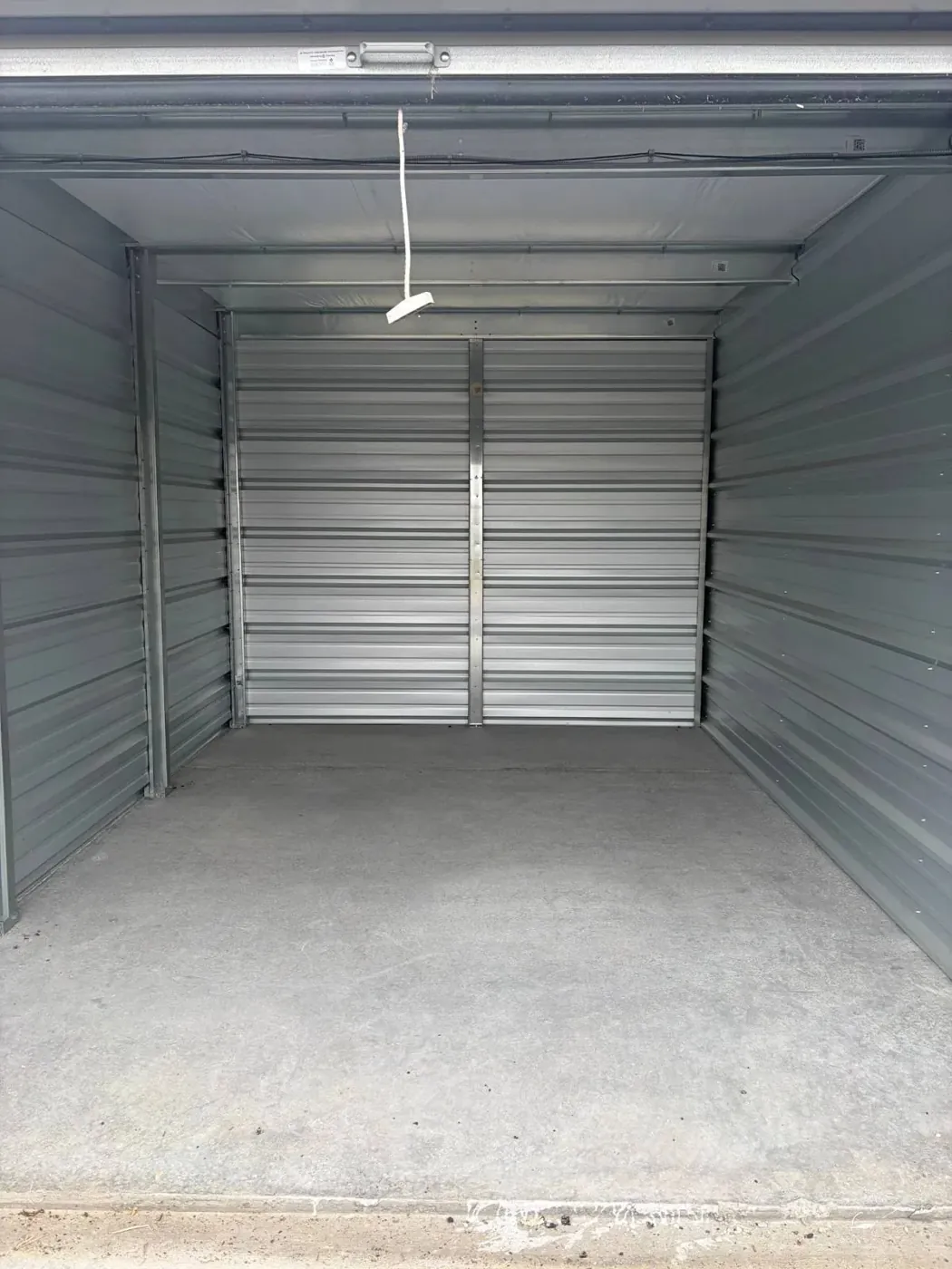 Empty metal storage unit viewed from its doorway